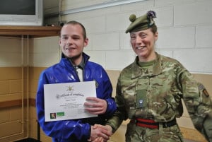 Sean Thain receives his certificate from Major Susan Duthie.