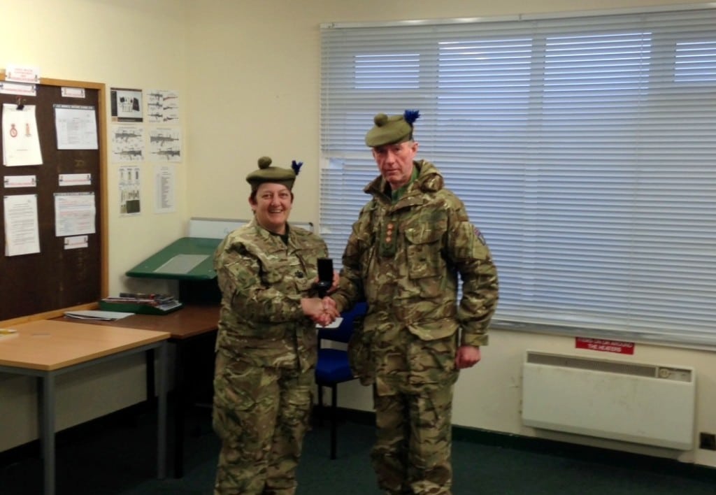 CSMI Woolley being presented with her 2nd clasp by Col Cassidy.