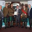 Inverness Caledonian Thistle staff posing with Armed Forces Covenant certificate