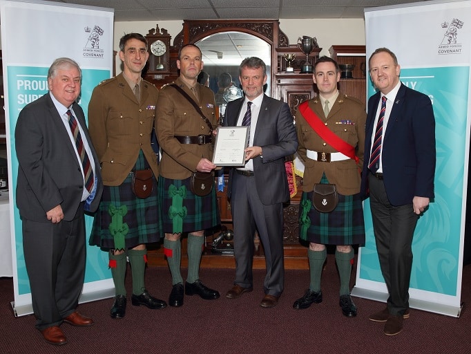 Inverness Caledonian Thistle staff posing with Armed Forces Covenant certificate