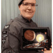 Alfie Robertson holding image of planets