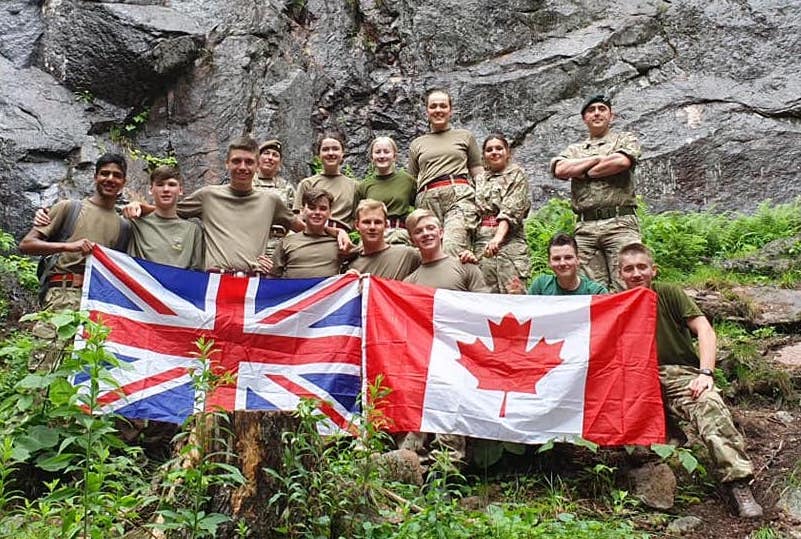 Cadets holding a Union Jack and Canada flags