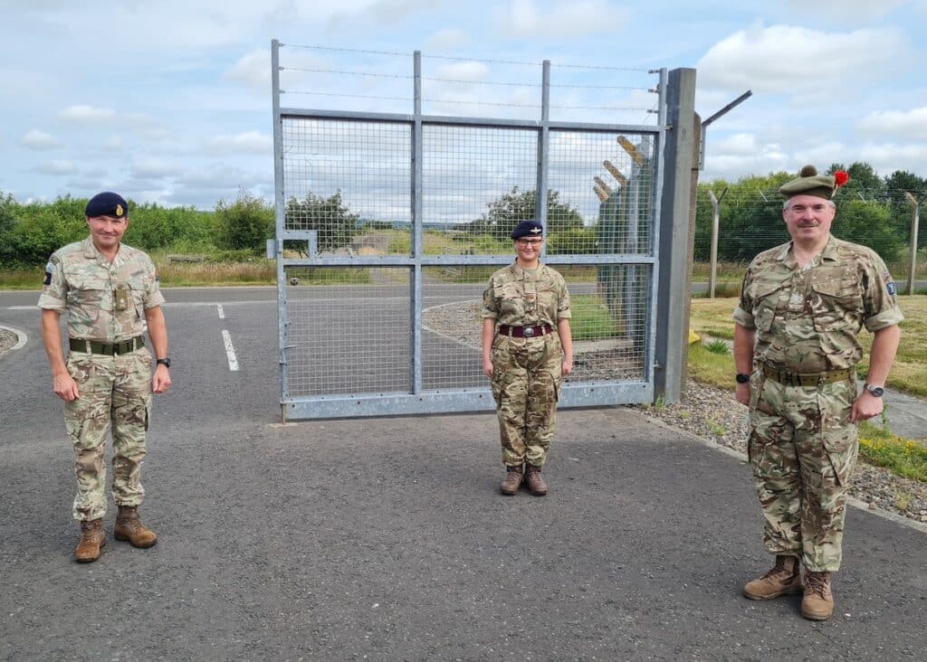 Major General with a cadet and adult volunteer.