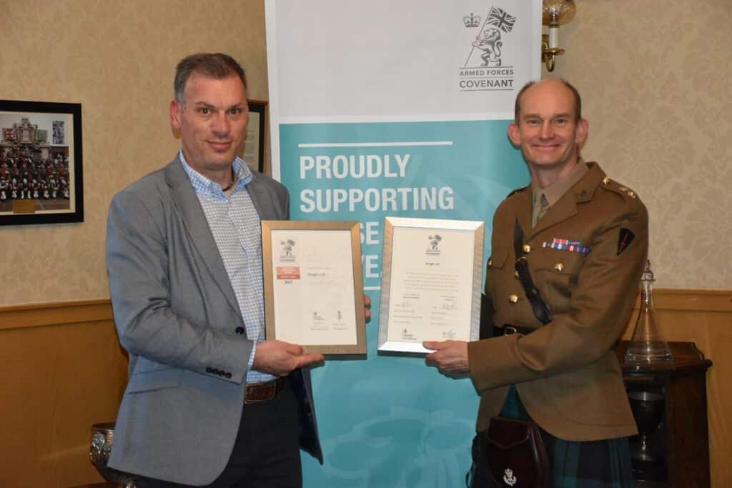 Army officer and employer holding certificates.