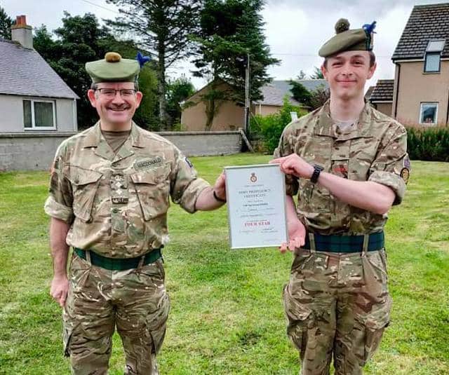 Cadet receiving certificate from Commandant.