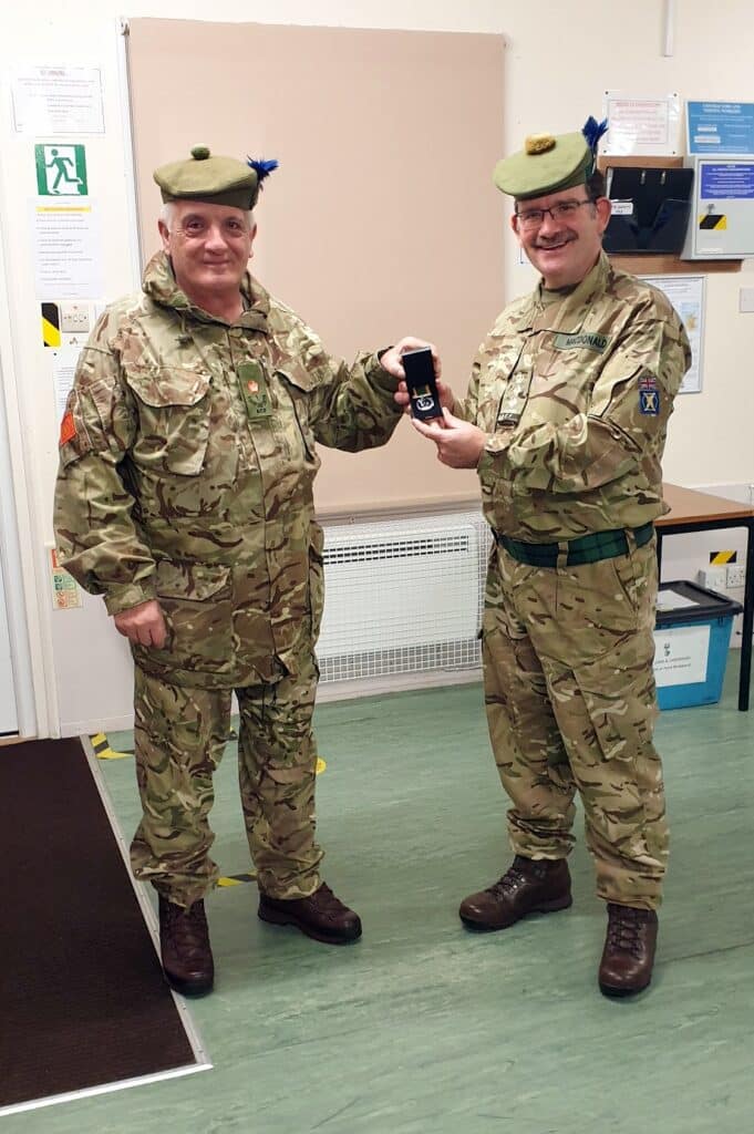 Major receives long service medal.