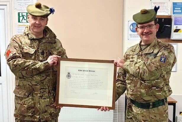 Cadet volunteer receives award from commandant.