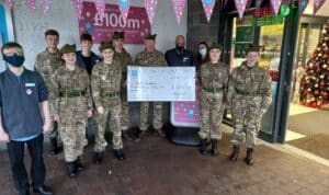 Kyle Detachment accepting a cheque for £5031.08 raised by the Co-op Members of Kyle of Lochalsh.