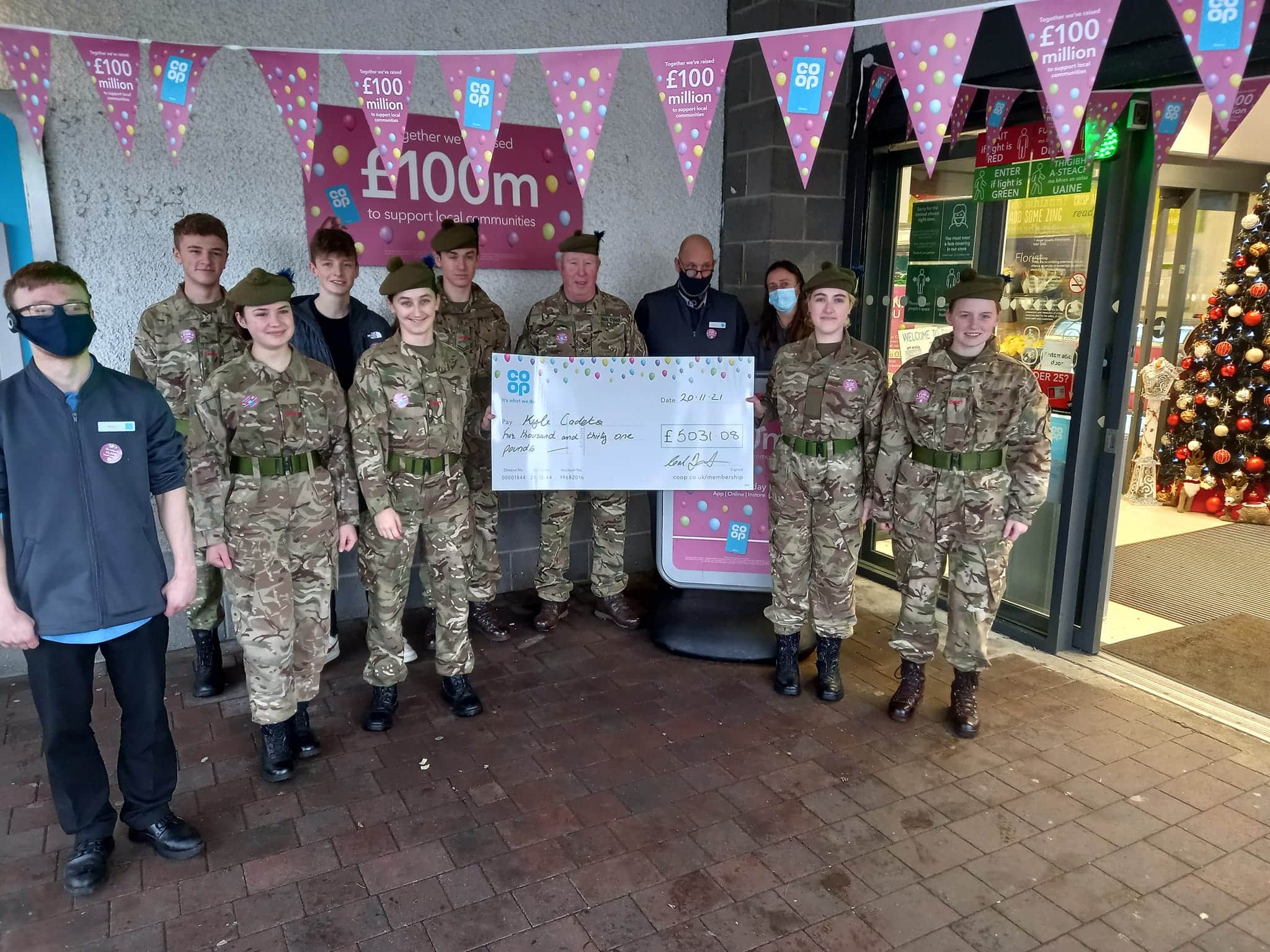 Kyle Detachment accepting a cheque for £5031.08 raised by the Co-op Members of Kyle of Lochalsh.