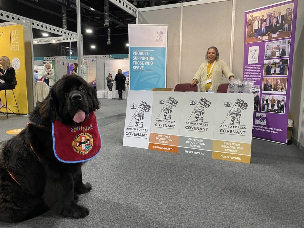 Yogi the Newfie at the HRFCA stand as Shabnum Akhtar-Dobson looks on.