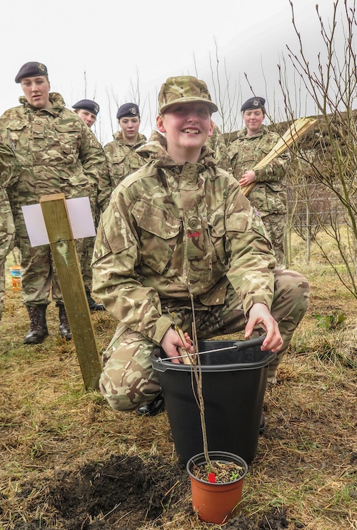 Cdt Enoch Gakere planting a tree for the Queen's Green Canopy.