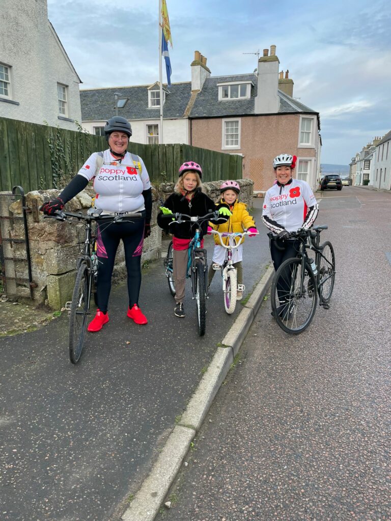 Flora (left) completing her cycle challenge.