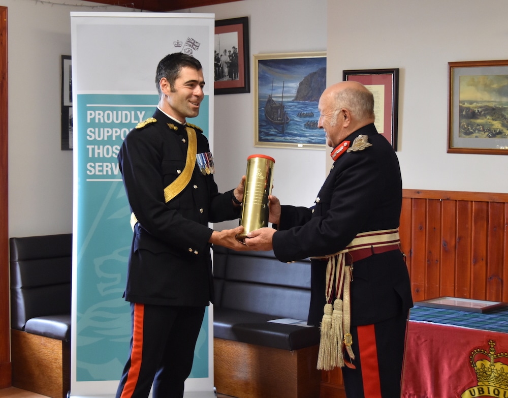 Lord-Lieutenant Bobby Hunter receives a gift of an engraved shell casing.