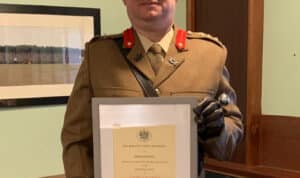 Colonel Gordon Rae with his certificate.