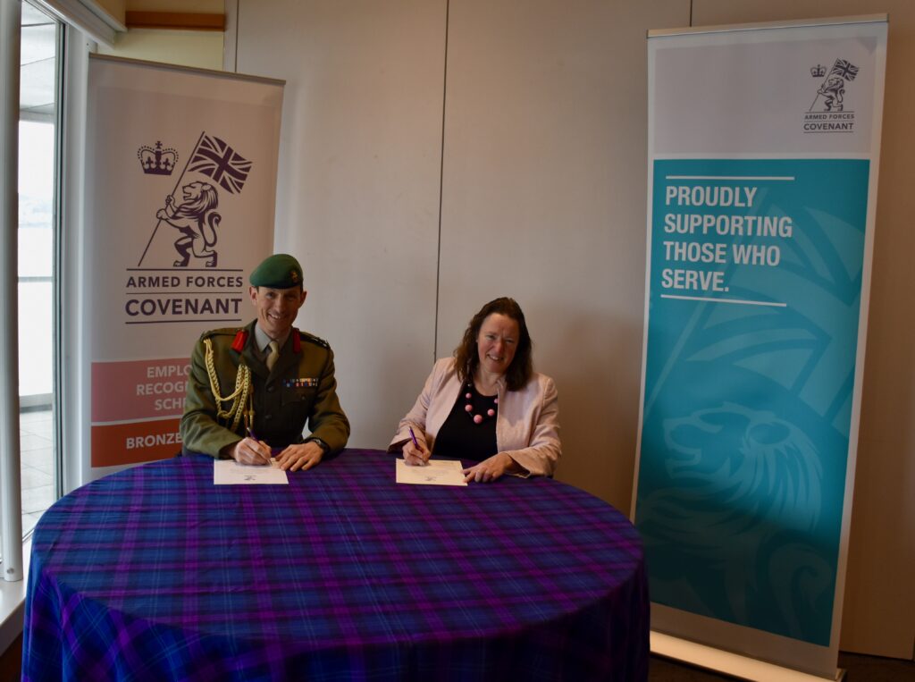 Naval Regional Commander for Scotland and Northern Ireland and Dundee Heritage Trust Deirdre Robertson signing the Armed Forces Covenant