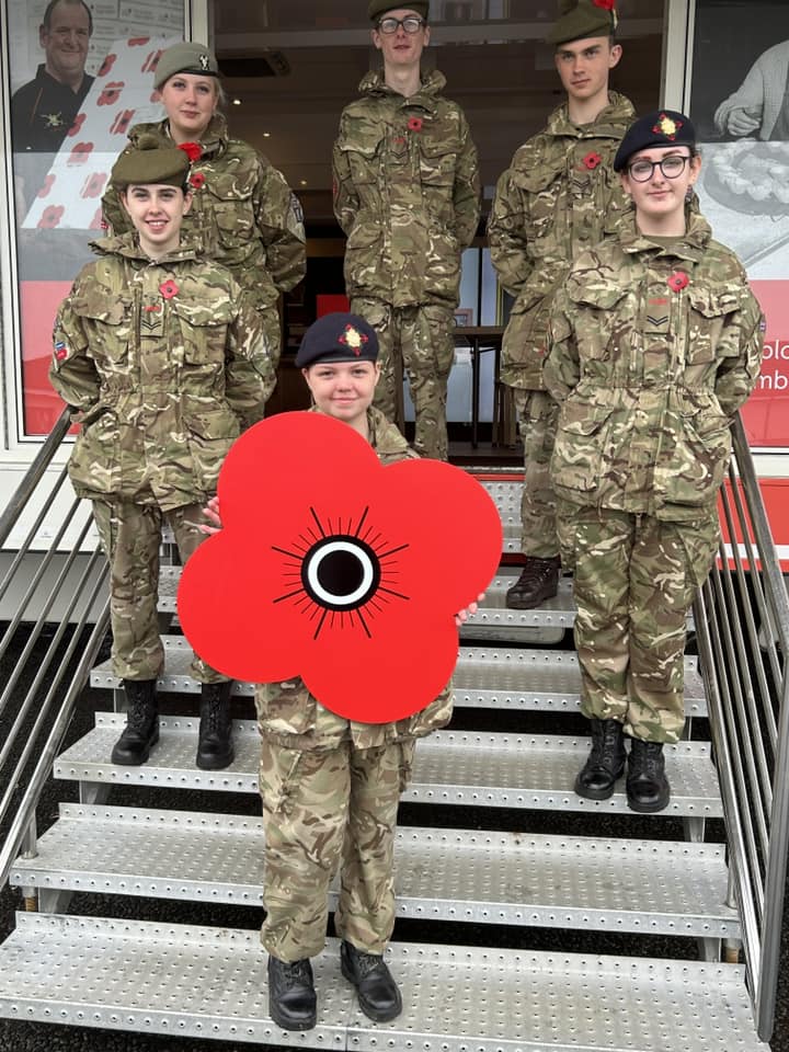 group of cadets posing with a poppy cutout