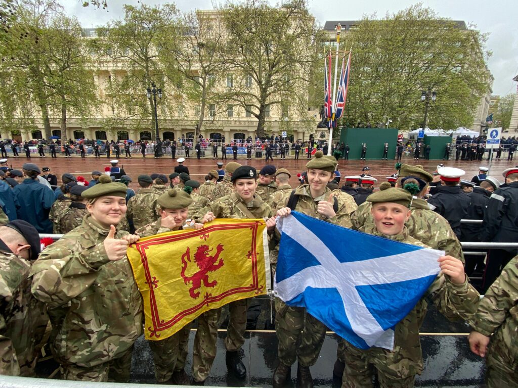 Five cadets holding up flags