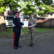 Cadet and Lord-Lieutenant show off certificate.