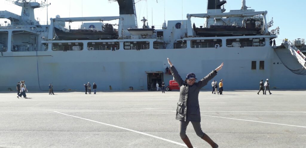 Anne Repo jumping in front of HMS Albion