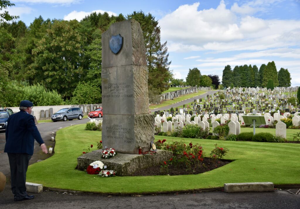 Local dignitary saluting wreath at memorial