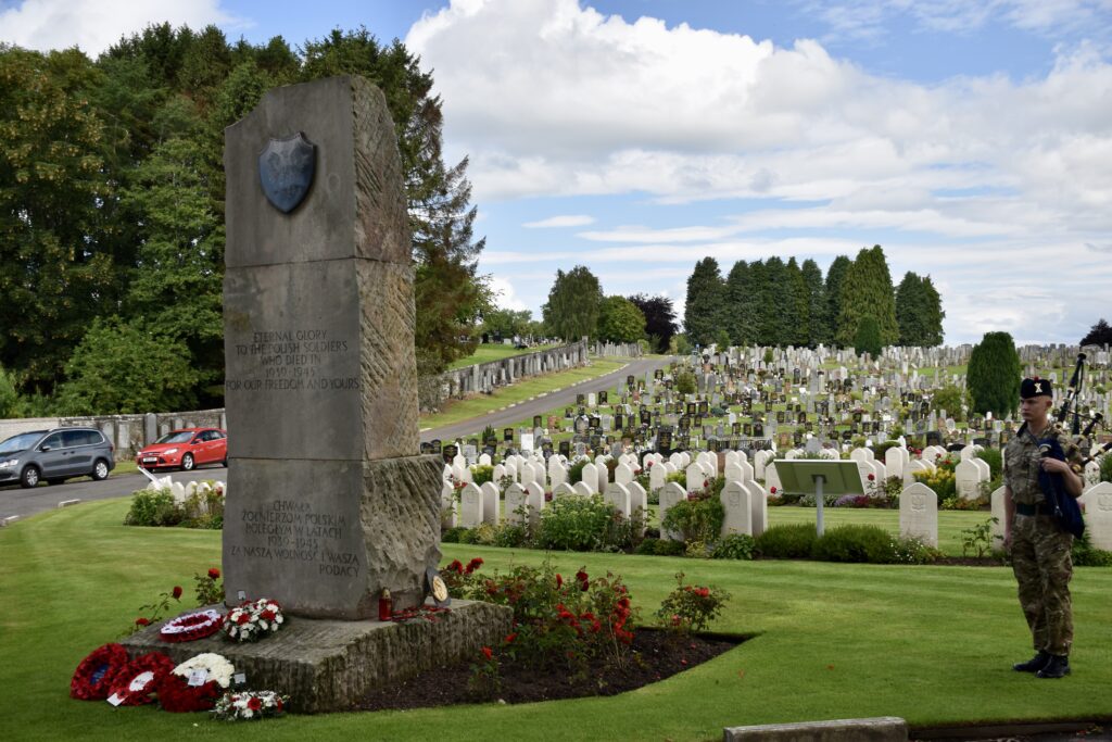 Cadet piper next to memorial