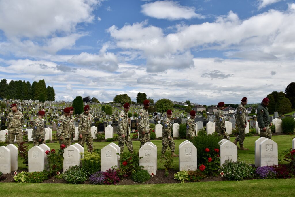 Polish Adult Volunteer and eleven cadets looking at war graves