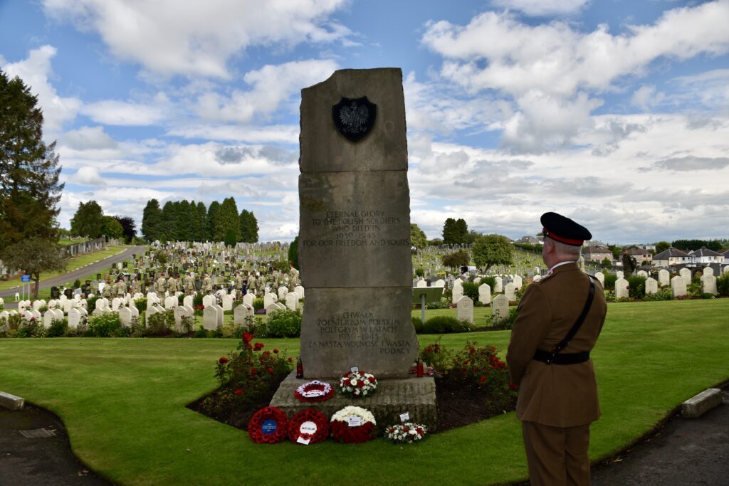 Army Cadets Head of Wellbeing in front of memorial