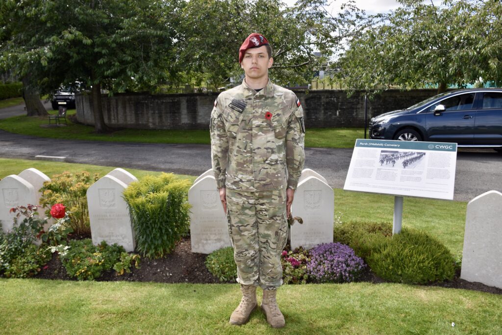 Cadet standing in front of war graves