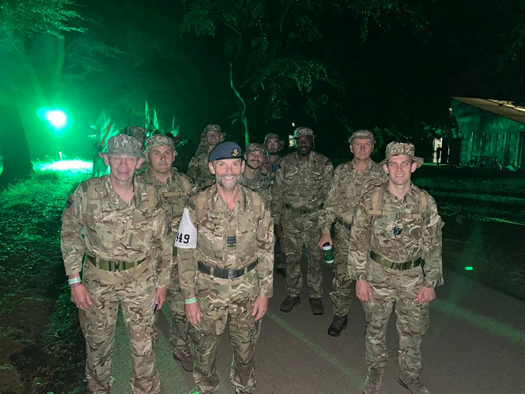 Ten military personnel smiling