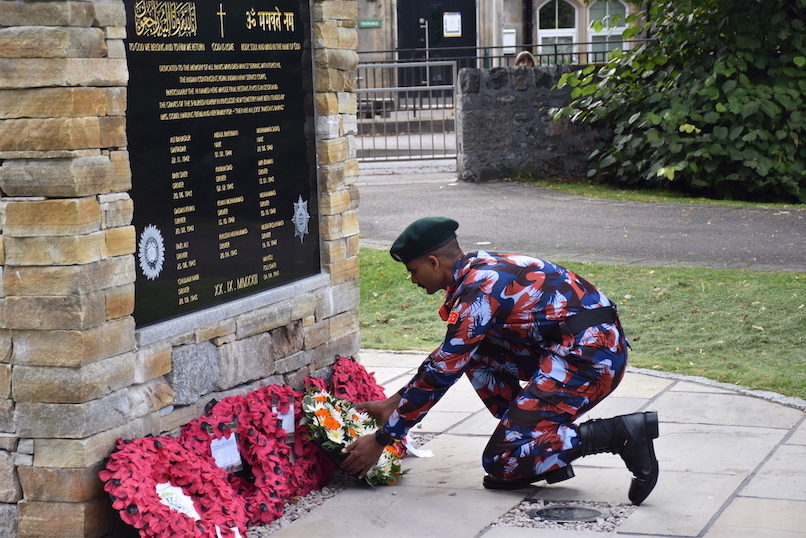 An Indian cadet laying a wreath.