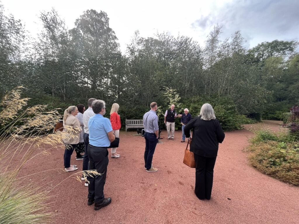 Highland Gold Network visitors in the memorial garden.