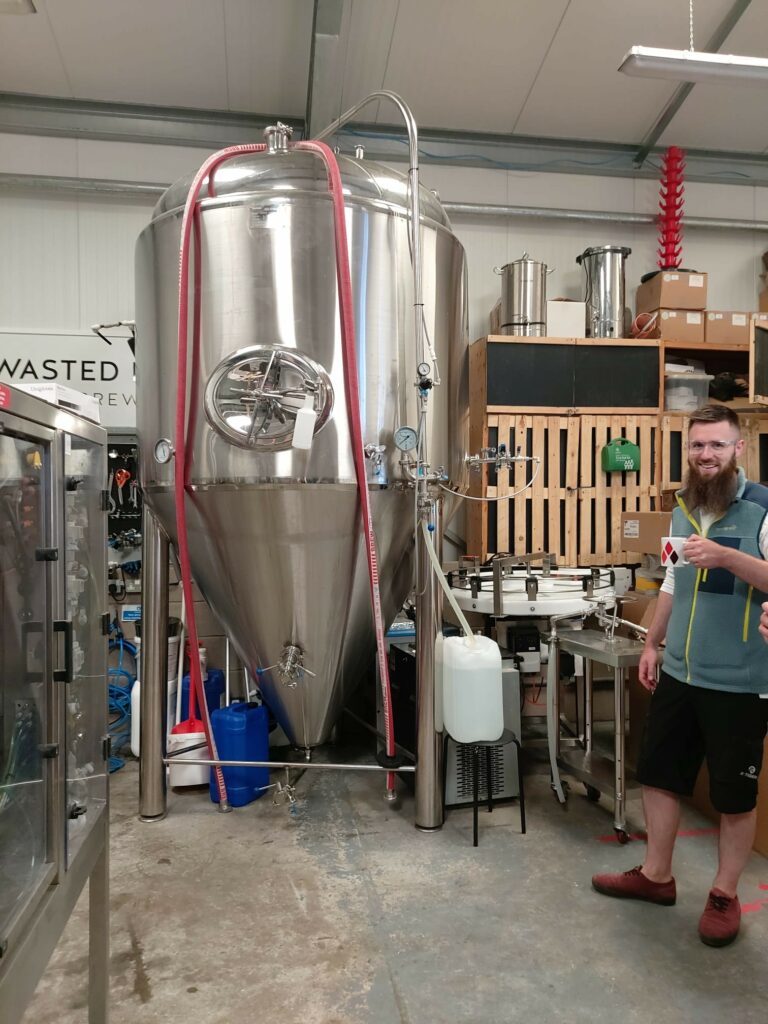 Brewery tank and one of the owners
