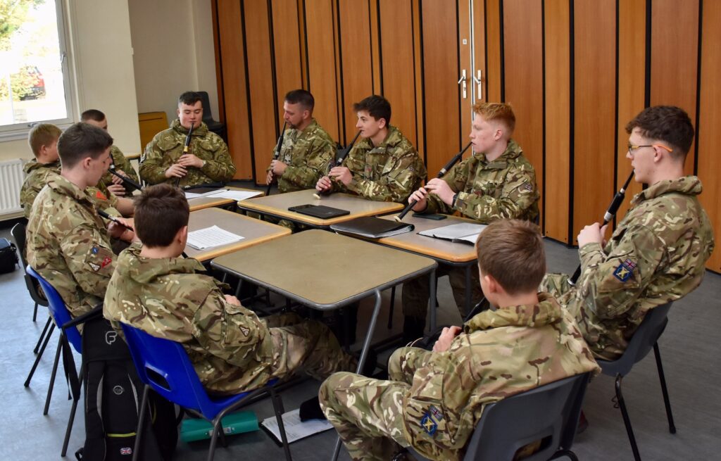 A group practises with their chanters.