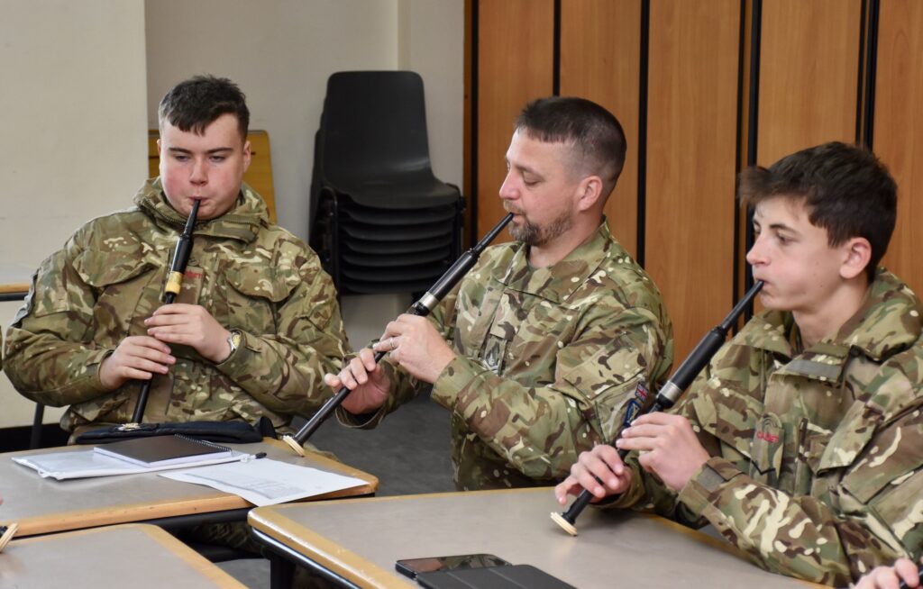 An instructor plays along with the cadets.