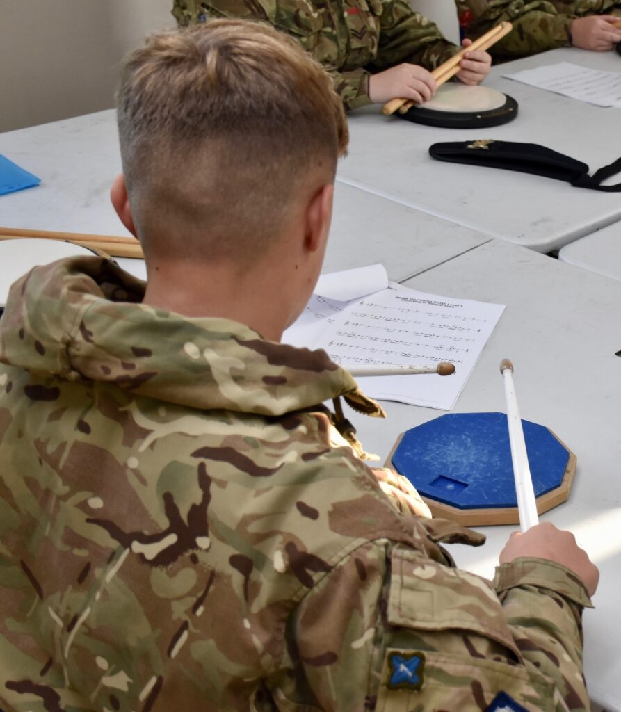 A cadet practises drumming.