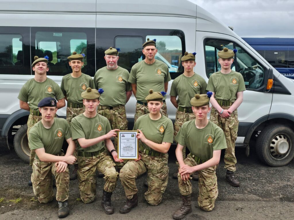 Cadets and staff with a certificate.