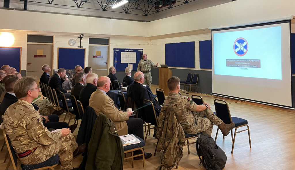 Commanding Officer of 215 Multirole Medical Regiment presenting to the seated attendees