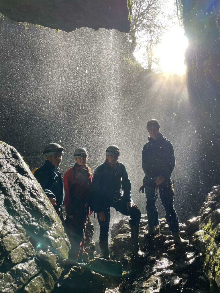 Four members of the training group in a cave.