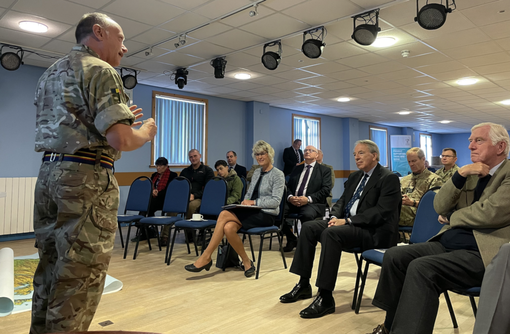 Officer Commanding of 157 Company speaking to the seated Northern Area Committee