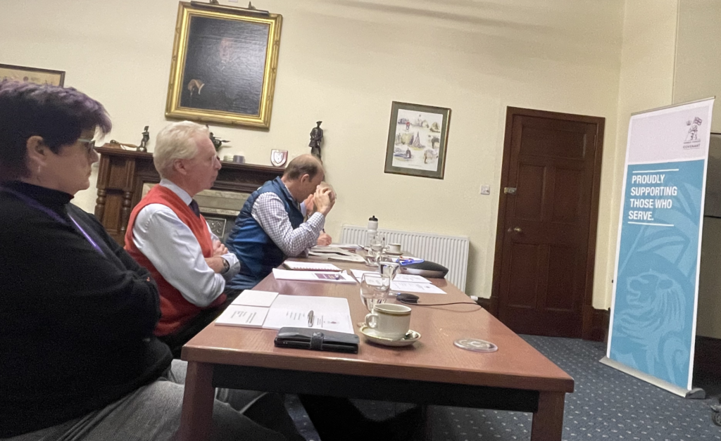 Four people sitting in conference room