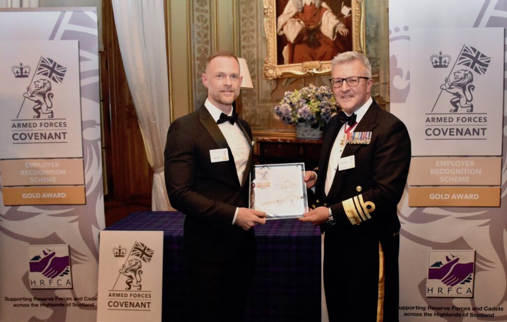 Trident IES receiving the Award from Vice Admiral Hally.