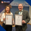 Samantha Johnston and Ray Watt showing off Well-Safe Solution's Armed Forces Covenant and ERS Bronze Award certificates.