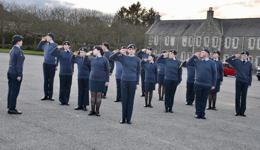 A large group of Cadets saluting.