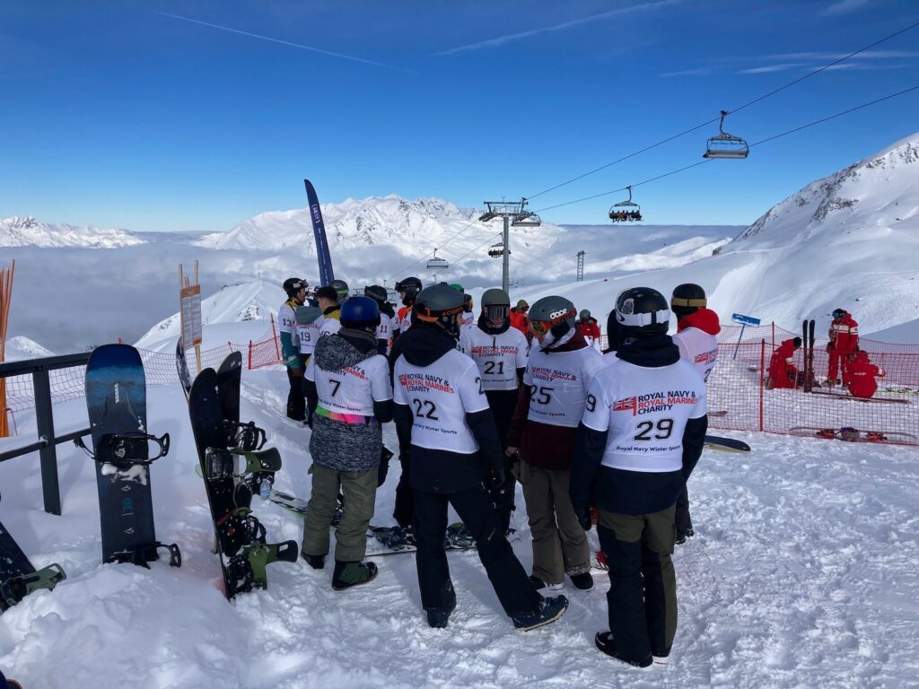 Royal Navy skiers and snowboarders close to a chair lift in Les Deux Alpes, France.