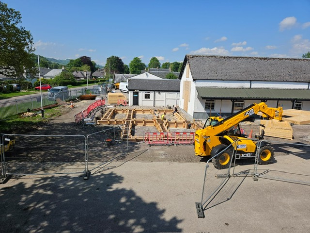 Plant machinery moving flat pack walls at the Dingwall Joint Cadet Centre site.