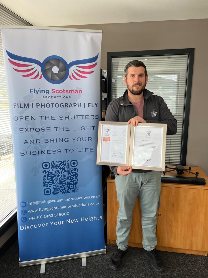 Scott MacDonald of Flying Scotsman holding two certificates.