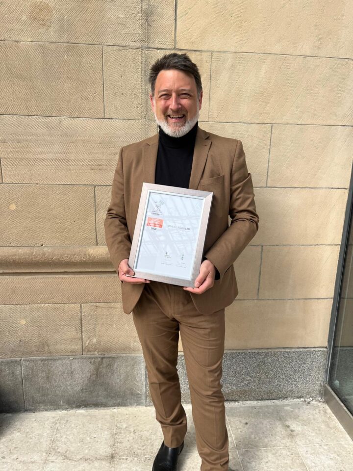 Man holding certificate.