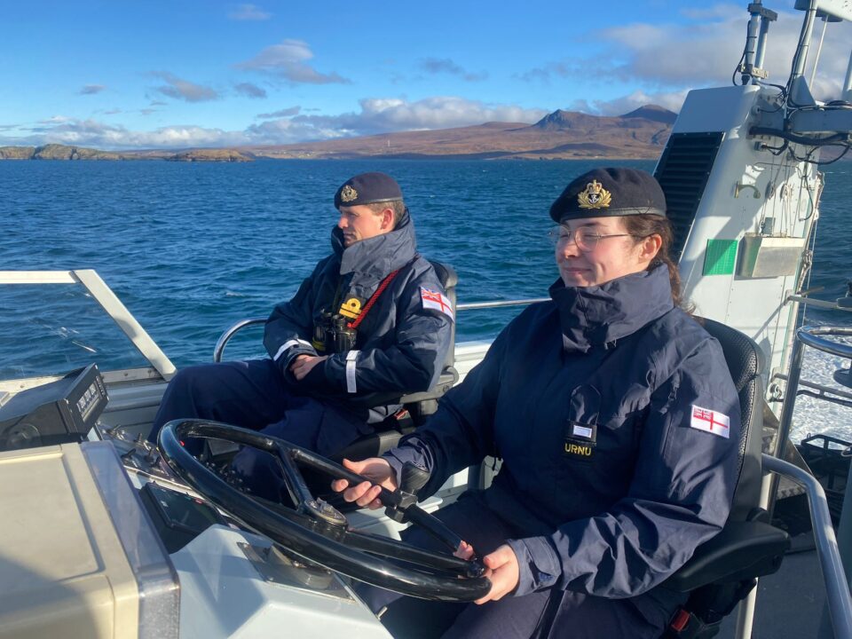 An URNU Officer Cadet at the helm of a P2000.