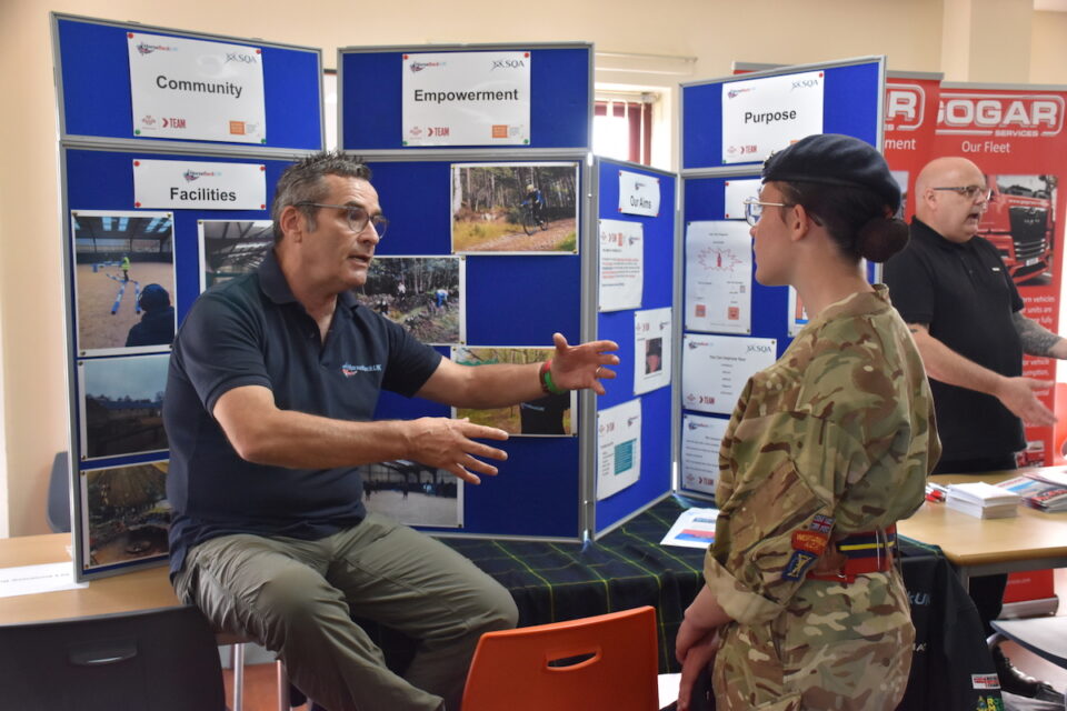 People chatting at information stands.