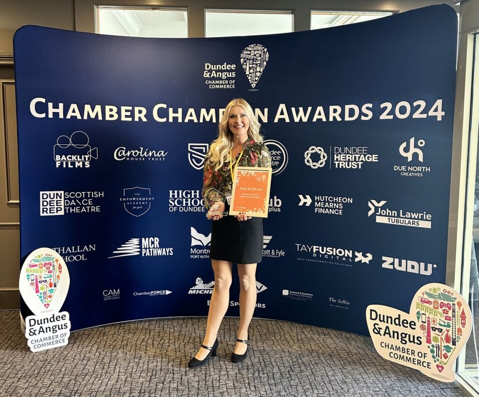 A representative from Scott & Fyfe Limited wholds their International Business Award.